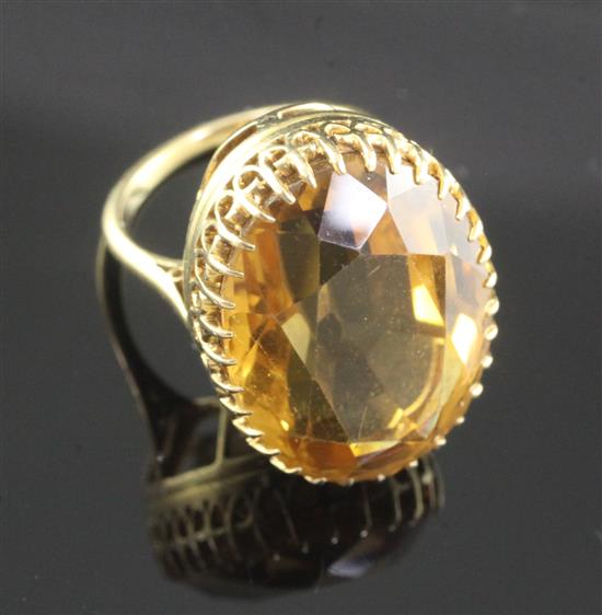 An 18ct gold and citrine set oval dress ring, size I.